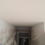 All walls are masked during ceiling texture removal in downtown Vancouver