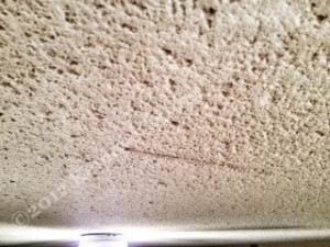 Damaged popcorn ceiling peeling off