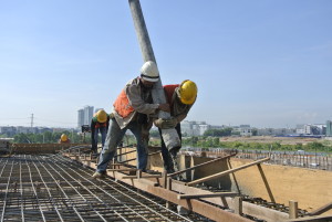 Concrete is poured into wood forms during construction